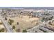 Bird's-eye view of a large field with scattered trees surrounded by residential buildings and streets at 11455 W 17Th Pl, Lakewood, CO 80215
