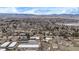 Aerial view of a neighborhood nestled among trees, with mountains in the distance at 11455 W 17Th Pl, Lakewood, CO 80215