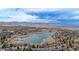 Breathtaking aerial shot of a tranquil lake bordered by a charming town nestled against majestic mountains at 11455 W 17Th Pl, Lakewood, CO 80215