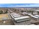 Wide aerial shot showcasing apartment buildings with covered parking, city, and landscape at 11455 W 17Th Pl, Lakewood, CO 80215