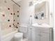 Bathroom featuring a bathtub with multi-colored tile, toilet, and a vanity with mirror at 11455 W 17Th Pl, Lakewood, CO 80215
