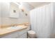 Cozy bathroom featuring a vanity with a sink, decorative starfish, and a shower with a white curtain at 11455 W 17Th Pl, Lakewood, CO 80215