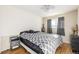 Neutral bedroom with hardwood floors, ceiling fan, large window and minimal decor at 11455 W 17Th Pl, Lakewood, CO 80215