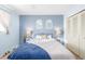 Comfortable bedroom with blue walls, stylish linens, and matching lamps flanking the bed at 11455 W 17Th Pl, Lakewood, CO 80215