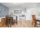 Dining room featuring hardwood floors, a stylish dining table, and an open layout at 11455 W 17Th Pl, Lakewood, CO 80215