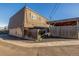 Exterior view of a multi-level property with a carport, a privacy fence and easy street access at 11455 W 17Th Pl, Lakewood, CO 80215