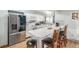 Modern kitchen featuring white cabinets, a stainless steel refrigerator, and a breakfast bar at 11455 W 17Th Pl, Lakewood, CO 80215
