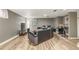 Relaxing living room with gray walls, a sectional sofa, a TV, and a bar area with stools at 11455 W 17Th Pl, Lakewood, CO 80215