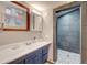 Updated bathroom with modern vanity and access to a large tiled shower at 4642 Plettner Ln, Evergreen, CO 80439