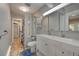 Bathroom featuring a double vanity, linen cabinet, and walk in shower at 4642 Plettner Ln, Evergreen, CO 80439