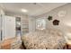 Cozy bedroom featuring decorative wall art, hardwood floors, and access to a charming closet at 4642 Plettner Ln, Evergreen, CO 80439