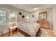 Comfortable bedroom features light-filled windows, wooden floors, and a stylish wooden dresser at 4642 Plettner Ln, Evergreen, CO 80439