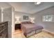 Serene bedroom with hardwood floors, bedside lamps, and ample natural light at 4642 Plettner Ln, Evergreen, CO 80439