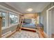 Bedroom featuring a bunk bed, wood floors, and large windows at 4642 Plettner Ln, Evergreen, CO 80439