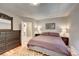 Inviting bedroom with a comfortable bed, natural light, and hardwood floors at 4642 Plettner Ln, Evergreen, CO 80439