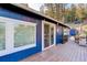 Exterior view of the home featuring a wood deck and sliding glass door at 4642 Plettner Ln, Evergreen, CO 80439