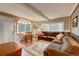 Spacious living room with large windows, comfortable seating, and a dining area at 4642 Plettner Ln, Evergreen, CO 80439