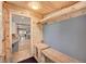 Mud room featuring wooden bench, hooks, and view into the kitchen at 4642 Plettner Ln, Evergreen, CO 80439