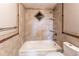 A beige-tiled bathroom featuring a tub, shower, and decorative diamond tile pattern at 4392 E 126Th Pl, Thornton, CO 80241