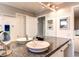 Bright bathroom with double sinks, granite counters, and white cabinetry at 4392 E 126Th Pl, Thornton, CO 80241