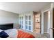 This bedroom features sliding glass closet doors and an en-suite bathroom at 4392 E 126Th Pl, Thornton, CO 80241