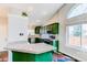 Bright kitchen features green cabinets, stainless steel appliances, granite countertops, and a vaulted ceiling at 4392 E 126Th Pl, Thornton, CO 80241