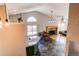 Open living room with a fireplace, dining area, and kitchen bar seating at 4392 E 126Th Pl, Thornton, CO 80241