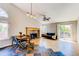 Spacious living room with a cozy fireplace and sliding glass door to the backyard at 4392 E 126Th Pl, Thornton, CO 80241