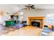 Open-concept living space with fireplace that connects the kitchen, dining, and living areas at 4392 E 126Th Pl, Thornton, CO 80241