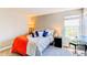 Main bedroom features a queen bed, bedside tables, and natural light from a large window at 4392 E 126Th Pl, Thornton, CO 80241