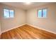 Empty bedroom with hardwood floors, windows, and neutral paint, ready for personalization at 10253 W 68Th Way, Arvada, CO 80004