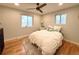 Bright bedroom with wood floors, two windows, and comfortable bedding and pillows at 10253 W 68Th Way, Arvada, CO 80004