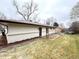 The home's rear exterior, with siding and brick accents, is complemented by a patio and well-maintained lawn at 10253 W 68Th Way, Arvada, CO 80004