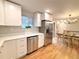 Bright, eat-in kitchen with stainless appliances, quartz counters, new cabinets and hardwood floors at 10253 W 68Th Way, Arvada, CO 80004