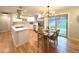 Bright, eat-in kitchen with stainless appliances, quartz counters, a custom hood vent and access to the yard at 10253 W 68Th Way, Arvada, CO 80004