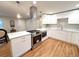 Modern kitchen with stainless appliances, quartz counters, new cabinets, and hardwood floors at 10253 W 68Th Way, Arvada, CO 80004