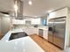Bright, modern kitchen with stainless appliances, quartz counters, new cabinets, and hardwood floors at 10253 W 68Th Way, Arvada, CO 80004
