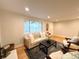 Bright living room featuring a tufted sofa, classic decor, hardwood floors, and natural light at 10253 W 68Th Way, Arvada, CO 80004