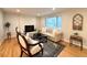 Cozy living room with fireplace, neutral colors, hardwood floors, and large window views at 10253 W 68Th Way, Arvada, CO 80004