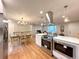 Open concept living space with updated kitchen, stainless appliances, quartz counters, and access to the living room at 10253 W 68Th Way, Arvada, CO 80004