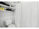 Bright bathroom featuring a tiled shower and storage shelves at 767 Ellis St, Golden, CO 80401