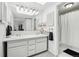 Bright bathroom with a double sink vanity and a full shower and tub at 767 Ellis St, Golden, CO 80401
