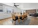 Open dining area with hardwood floors, large window and ceiling fan, adjacent to a brick fireplace at 767 Ellis St, Golden, CO 80401
