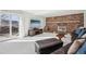 Cozy living room featuring a brick fireplace, sliding glass doors to the patio, and comfortable seating at 767 Ellis St, Golden, CO 80401