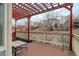 An outdoor deck with a pergola, overlooking a landscaped backyard and surrounding neighborhood at 16159 W 70Th Pl, Arvada, CO 80007