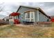 View of the home's exterior featuring a backyard, patio, and pergola-covered deck at 16159 W 70Th Pl, Arvada, CO 80007