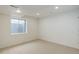 View of basement space with neutral carpet, recessed lights and an egress window at 16159 W 70Th Pl, Arvada, CO 80007