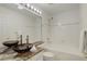 Modern bathroom featuring granite countertops, a vessel sink, and a soaking tub with shower at 16159 W 70Th Pl, Arvada, CO 80007