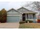 Charming single-Gathering home featuring a well-manicured front yard and an attached two-car garage at 16159 W 70Th Pl, Arvada, CO 80007