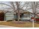 Charming single-story home with a covered front porch and attached garage at 16159 W 70Th Pl, Arvada, CO 80007